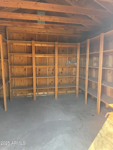 a view of an empty room with empty shelves