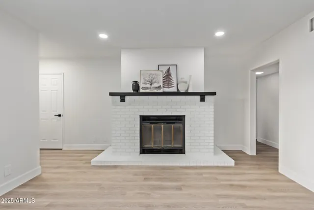 a living room with a fireplace and a wooden floor