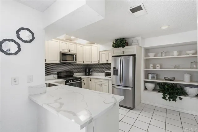 a kitchen with a refrigerator a microwave and cabinets