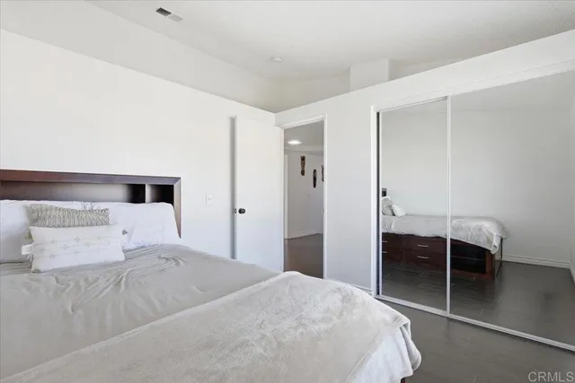 a bedroom with a bed and a desk