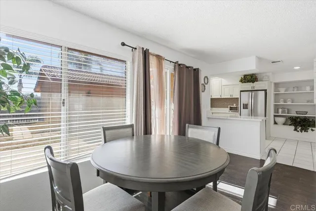 a dining room with furniture and wooden floor