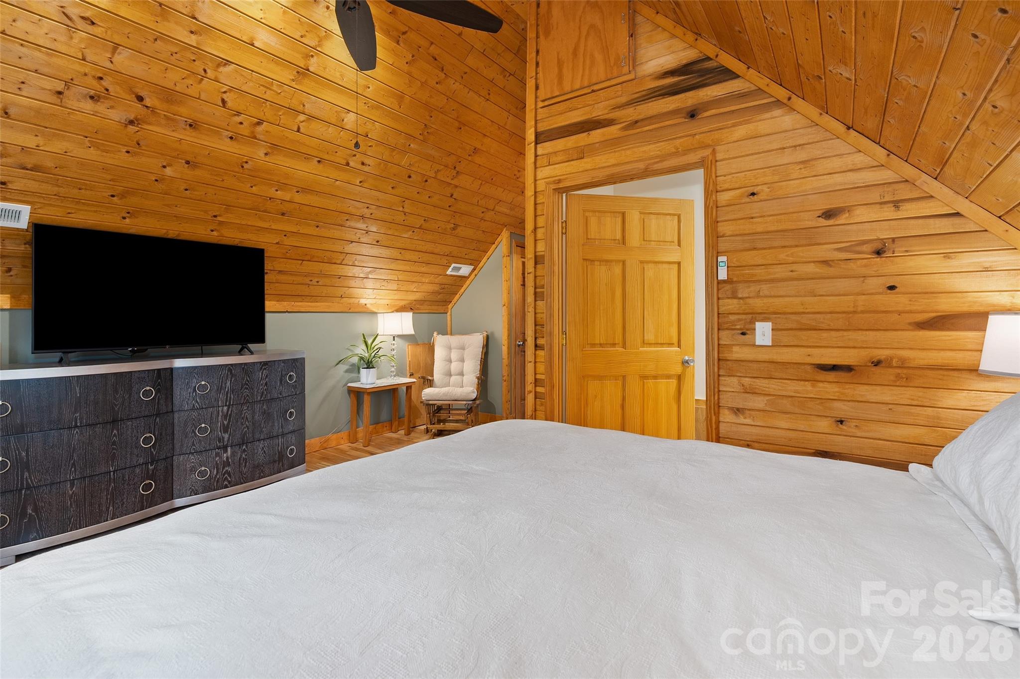 215 Atkins Loop Lake Junaluska, NC 28745 - Photo 19 of 44 a bedroom with a bed and a flat screen tv