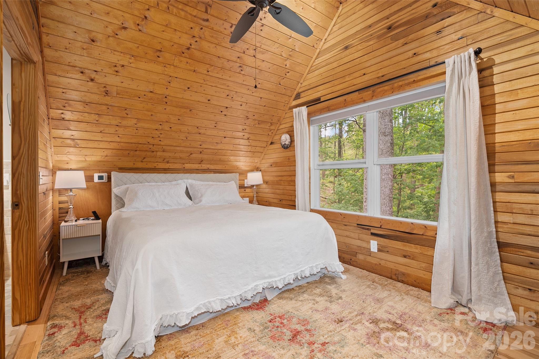 215 Atkins Loop Lake Junaluska, NC 28745 - Photo 20 of 44 a bedroom with a bed and a large window