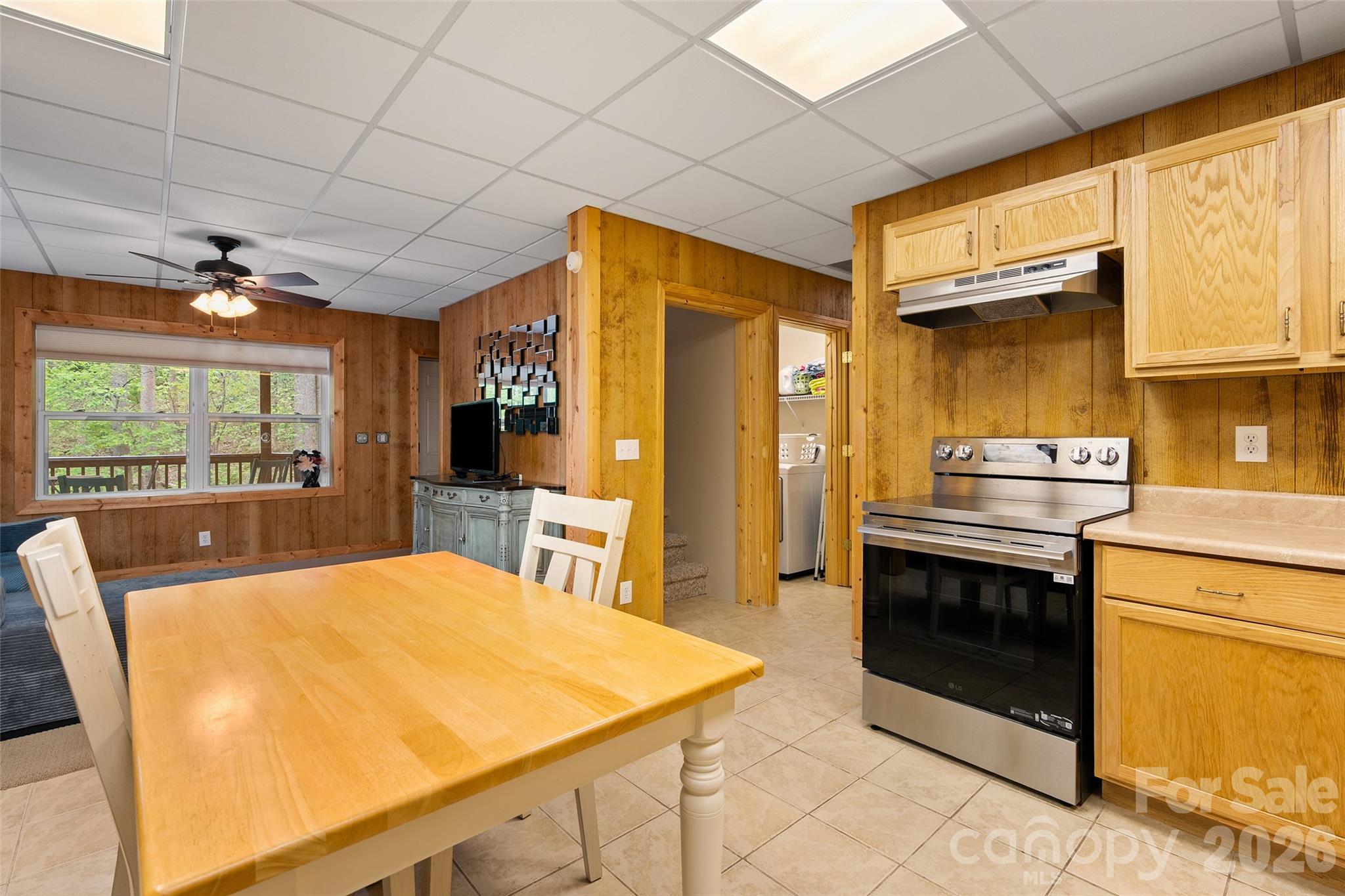 215 Atkins Loop Lake Junaluska, NC 28745 - Photo 27 of 44 a kitchen with stainless steel appliances kitchen island granite countertop a refrigerator a stove a sink dishwasher with a dining table and chairs with wooden floor