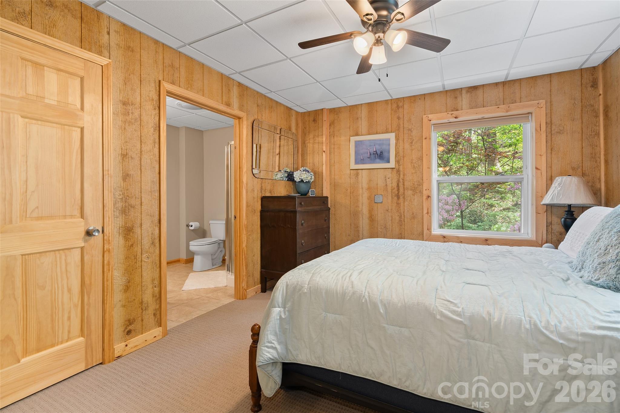 215 Atkins Loop Lake Junaluska, NC 28745 - Photo 36 of 44 a bedroom with a bed and a chandelier