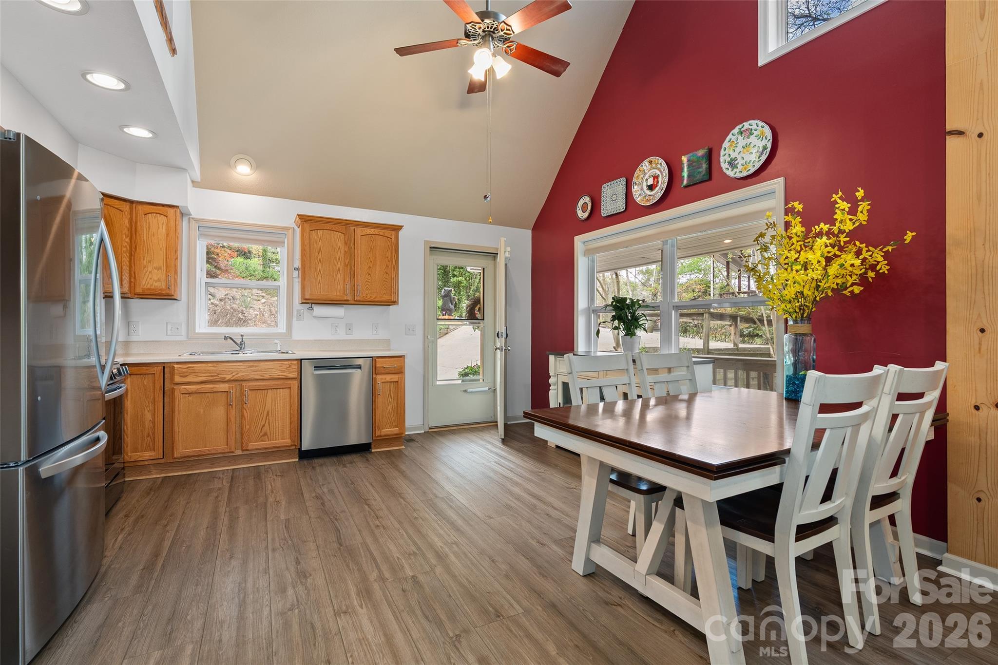 215 Atkins Loop Lake Junaluska, NC 28745 - Photo 5 of 44 a kitchen with stainless steel appliances kitchen island granite countertop a stove a sink and a refrigerator with wooden floor