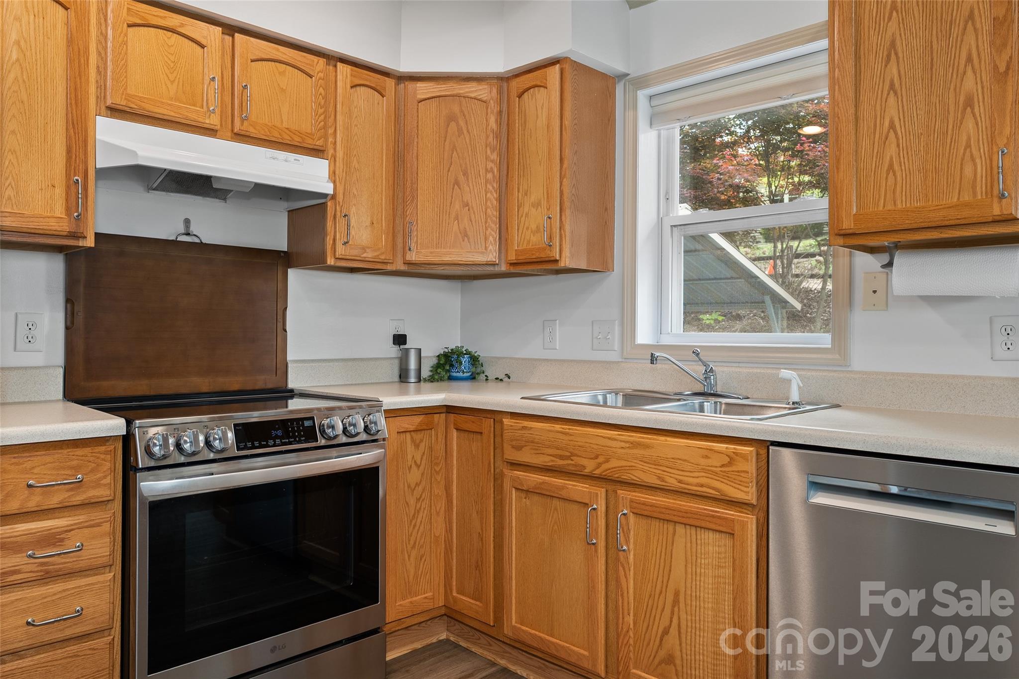 215 Atkins Loop Lake Junaluska, NC 28745 - Photo 7 of 44 a kitchen with stainless steel appliances granite countertop a stove sink and cabinets