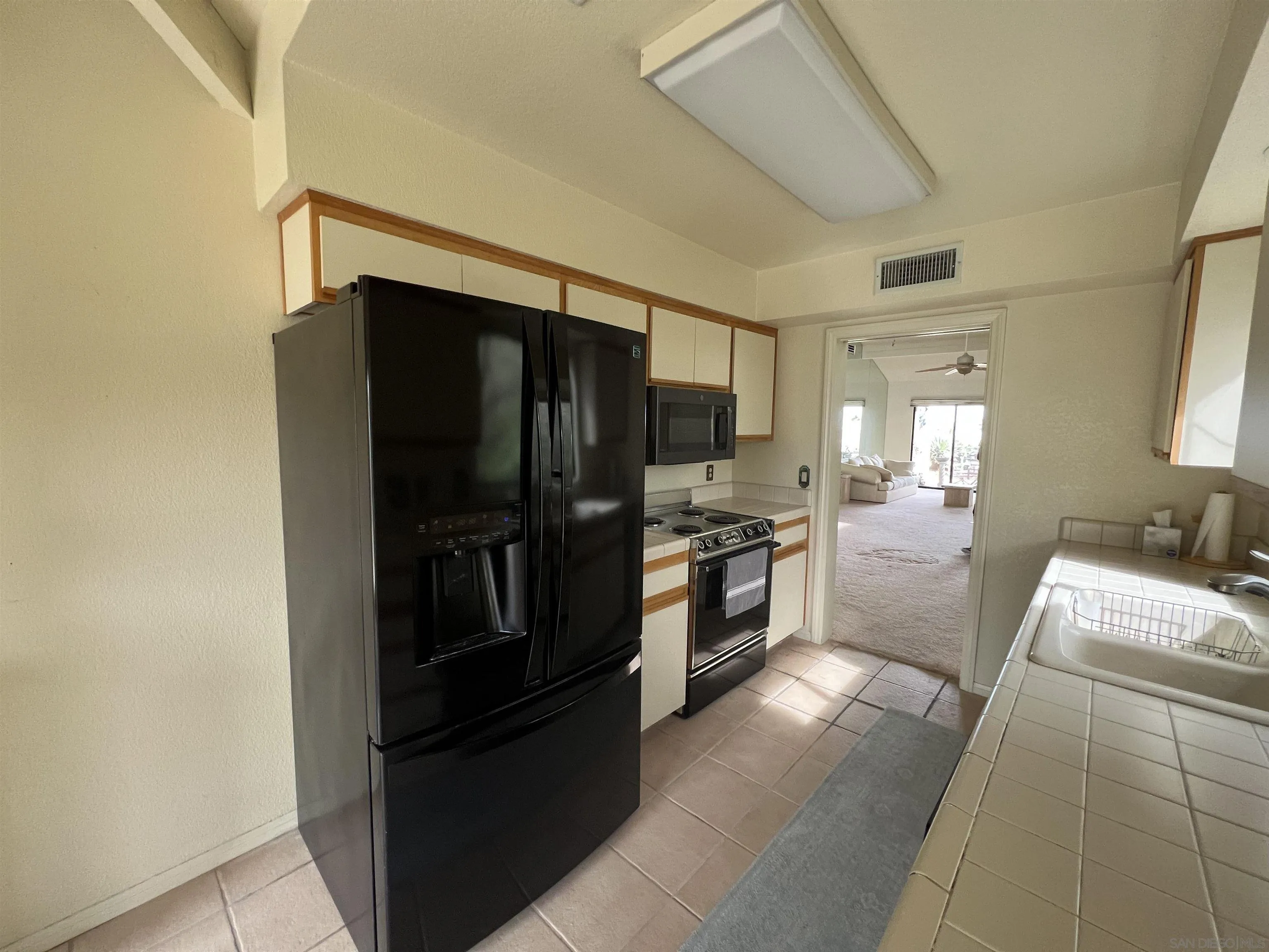 4683 Desert Vista Drive Borrego Springs, CA 92004 - Photo 15 of 32 a kitchen with a refrigerator and a sink