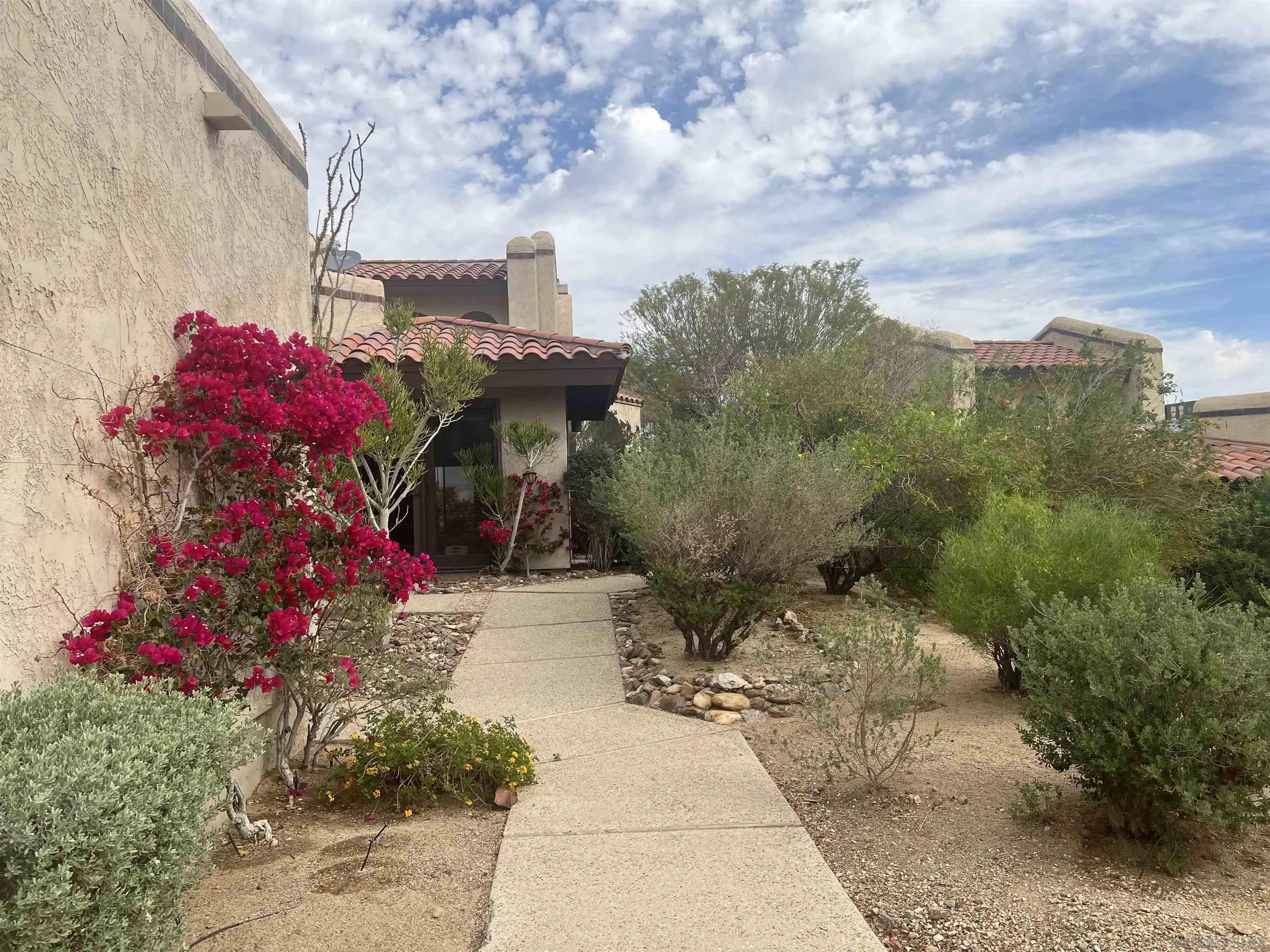 4683 Desert Vista Drive Borrego Springs, CA 92004 - Photo 6 of 32 a front view of a house with a yard and fountain
