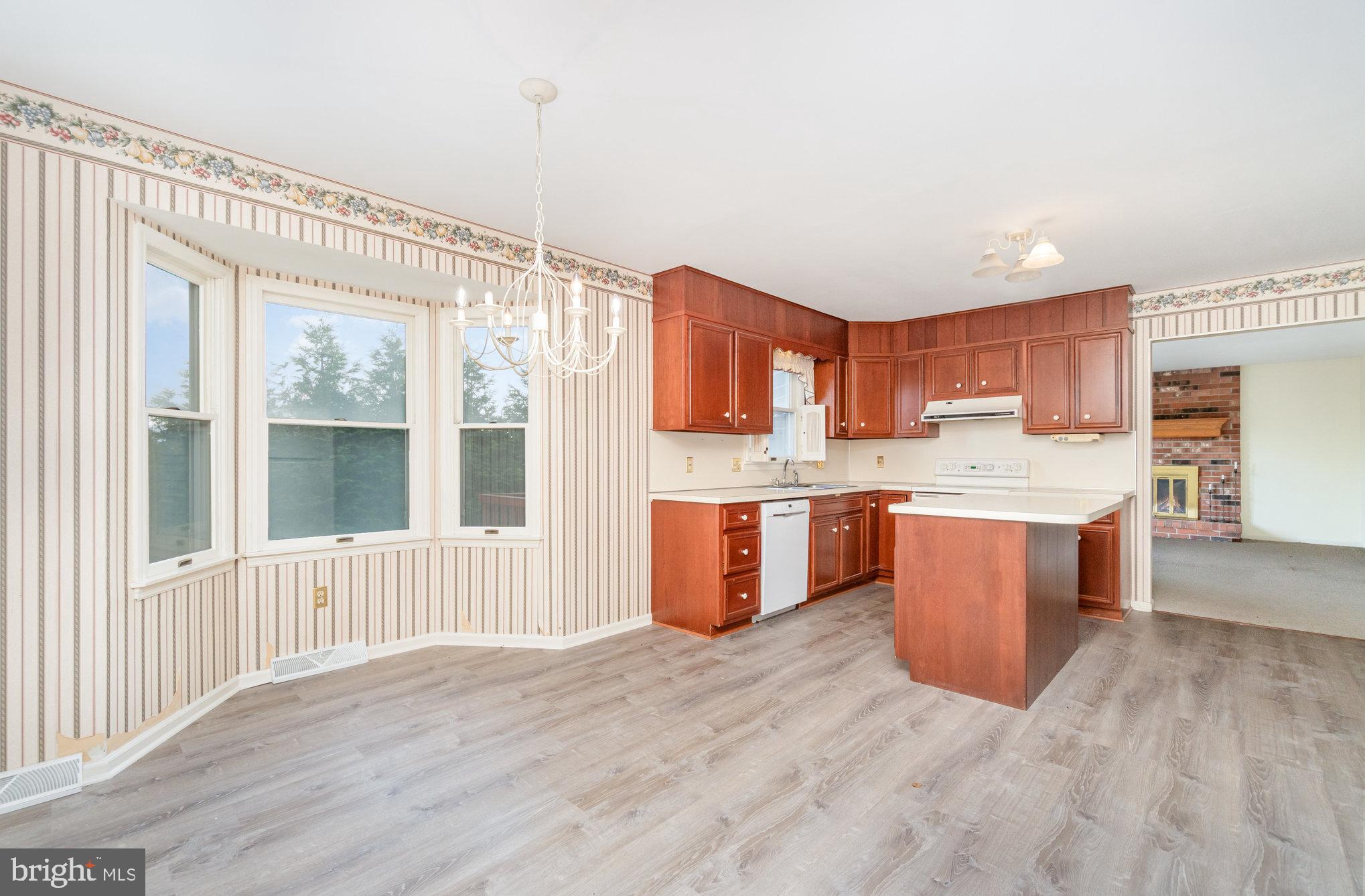 25 Estates Drive Reading, PA 19606 - Photo 15 of 43 a large kitchen with stainless steel appliances granite countertop a stove a sink dishwasher a refrigerator and wooden cabinets with wooden floor