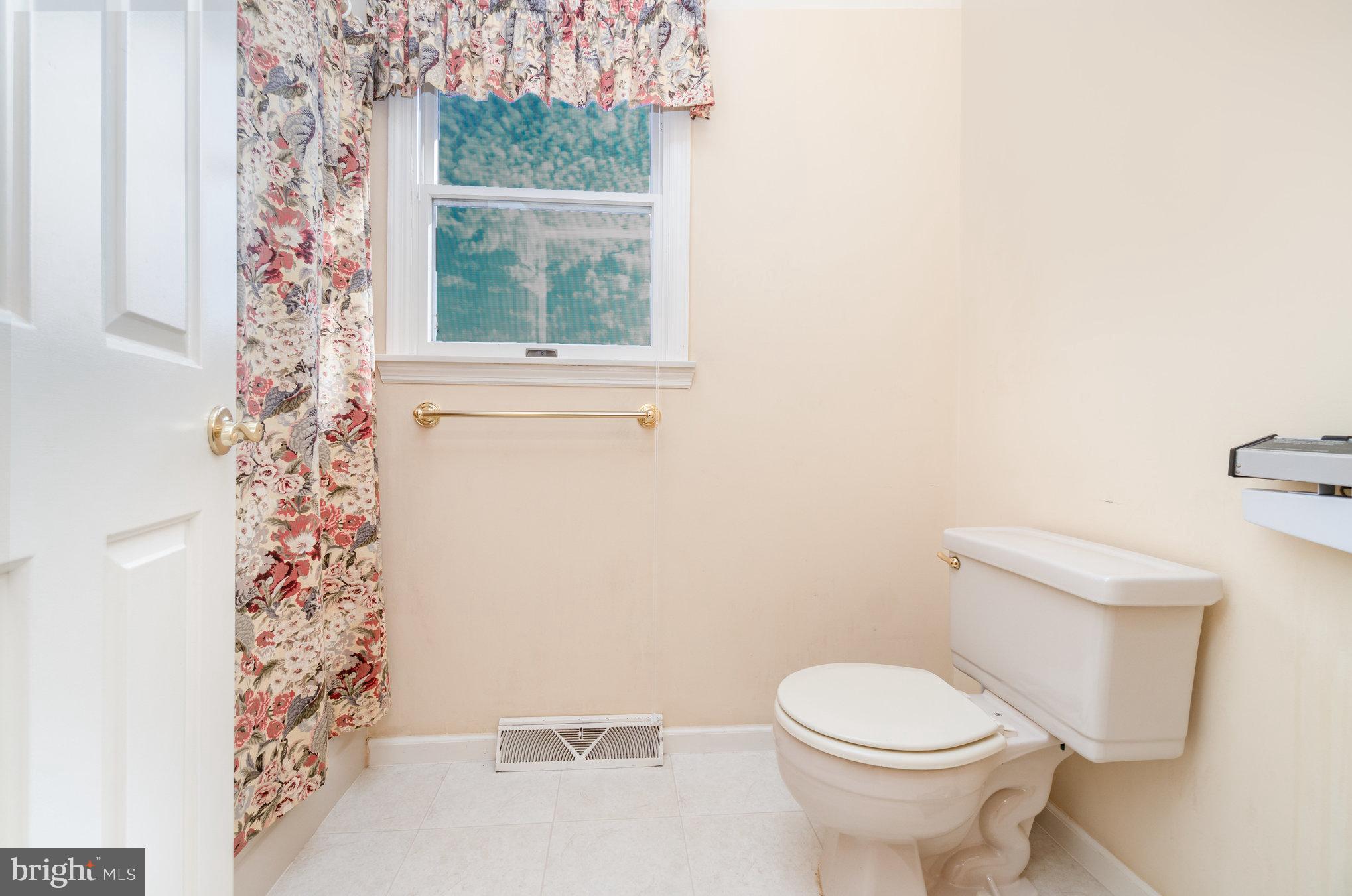 25 Estates Drive Reading, PA 19606 - Photo 22 of 43 a white toilet sitting next to a shower curtain