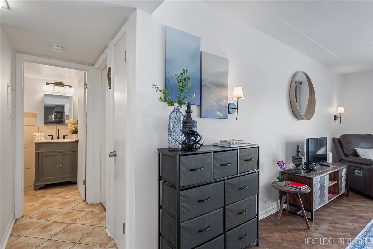 127 North Wolf Road, Unit 60A Wheeling, IL 60090 - Photo 12 of 22 a kitchen with a refrigerator and a stove top oven