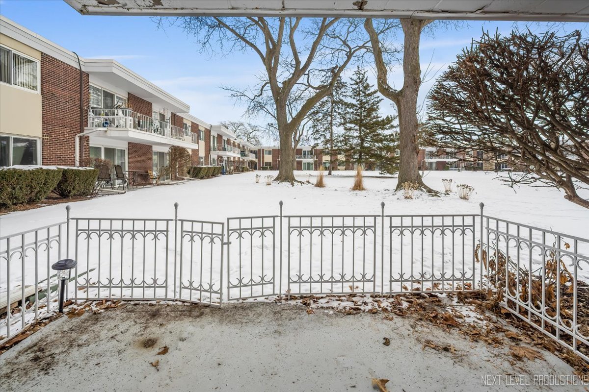 127 North Wolf Road, Unit 60A Wheeling, IL 60090 - Photo 13 of 22 a view of a house with a small yard