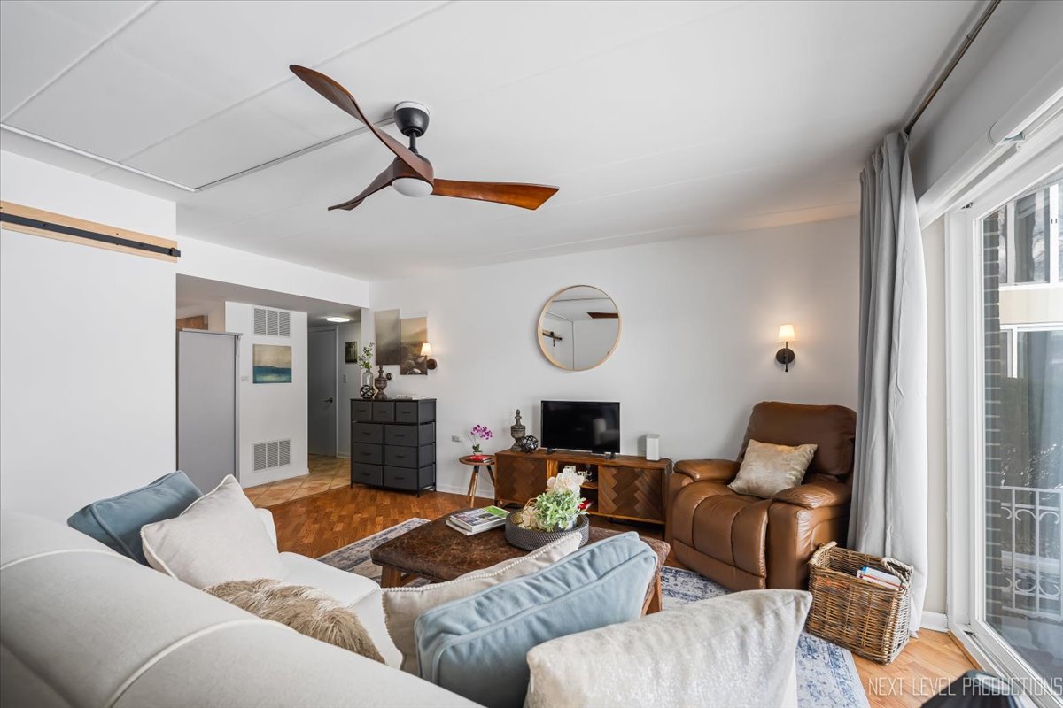 127 North Wolf Road, Unit 60A Wheeling, IL 60090 - Photo 4 of 22 a living room with furniture kitchen view and a window