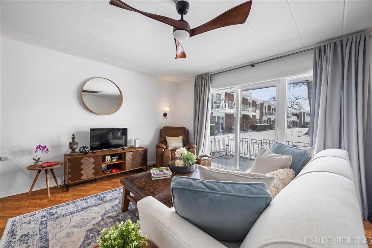127 North Wolf Road, Unit 60A Wheeling, IL 60090 - Photo 5 of 22 a living room with furniture a fireplace and a flat screen tv