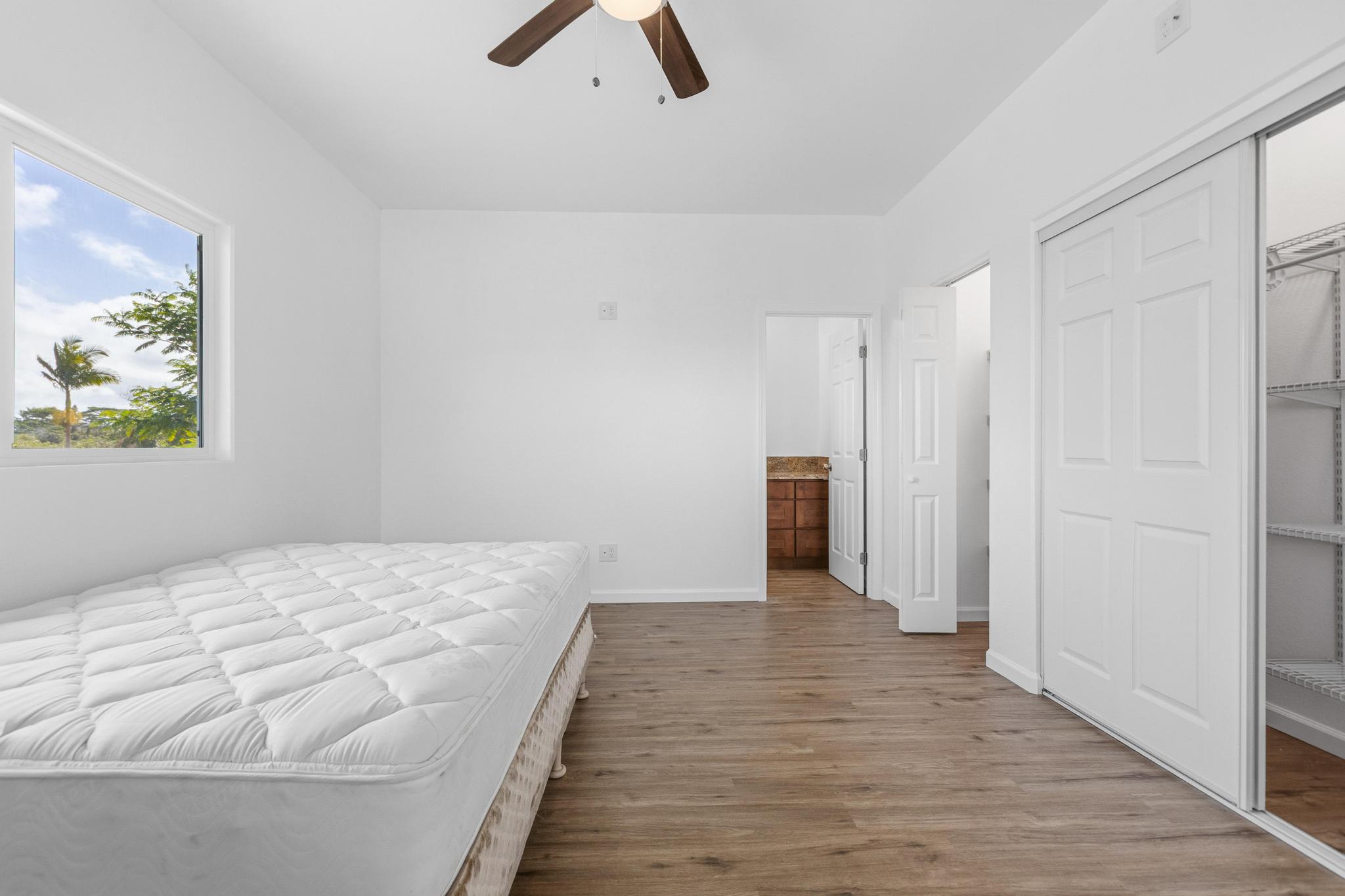 18-7842 Kaniela Road Mountain View, HI 96771 - Photo 14 of 30 a view of a bedroom with wooden floor and ceiling fan