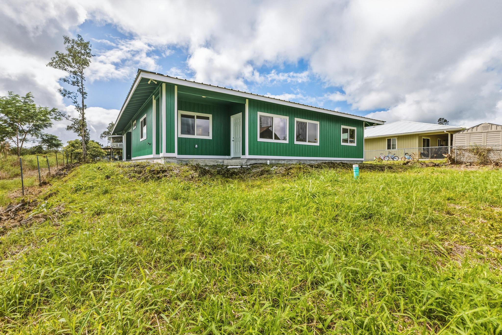 18-7842 Kaniela Road Mountain View, HI 96771 - Photo 2 of 30 a front view of a house with a garden