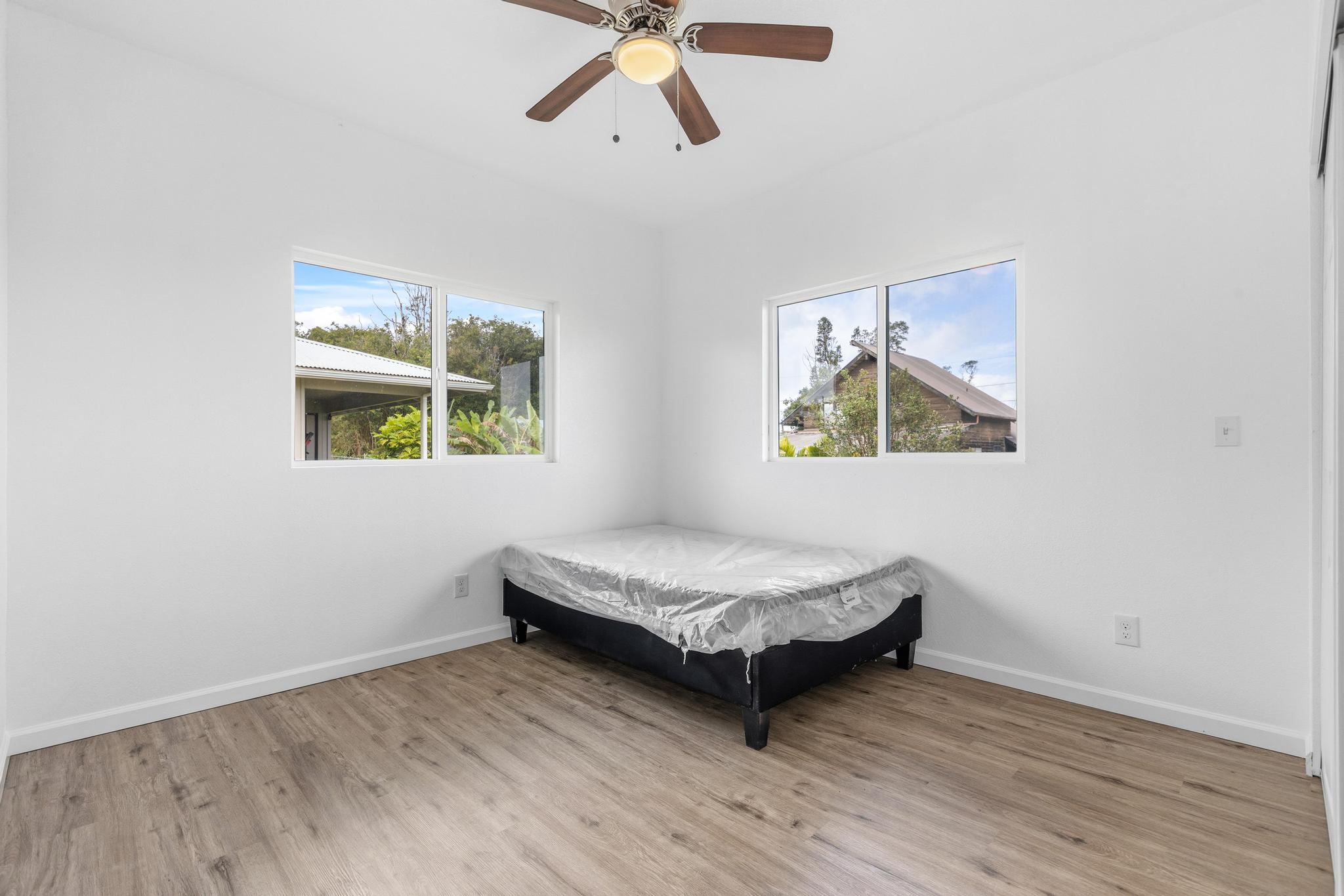 18-7842 Kaniela Road Mountain View, HI 96771 - Photo 21 of 30 a living room with a bed furniture and a window