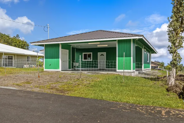 a view of a house with a swimming pool and a yard