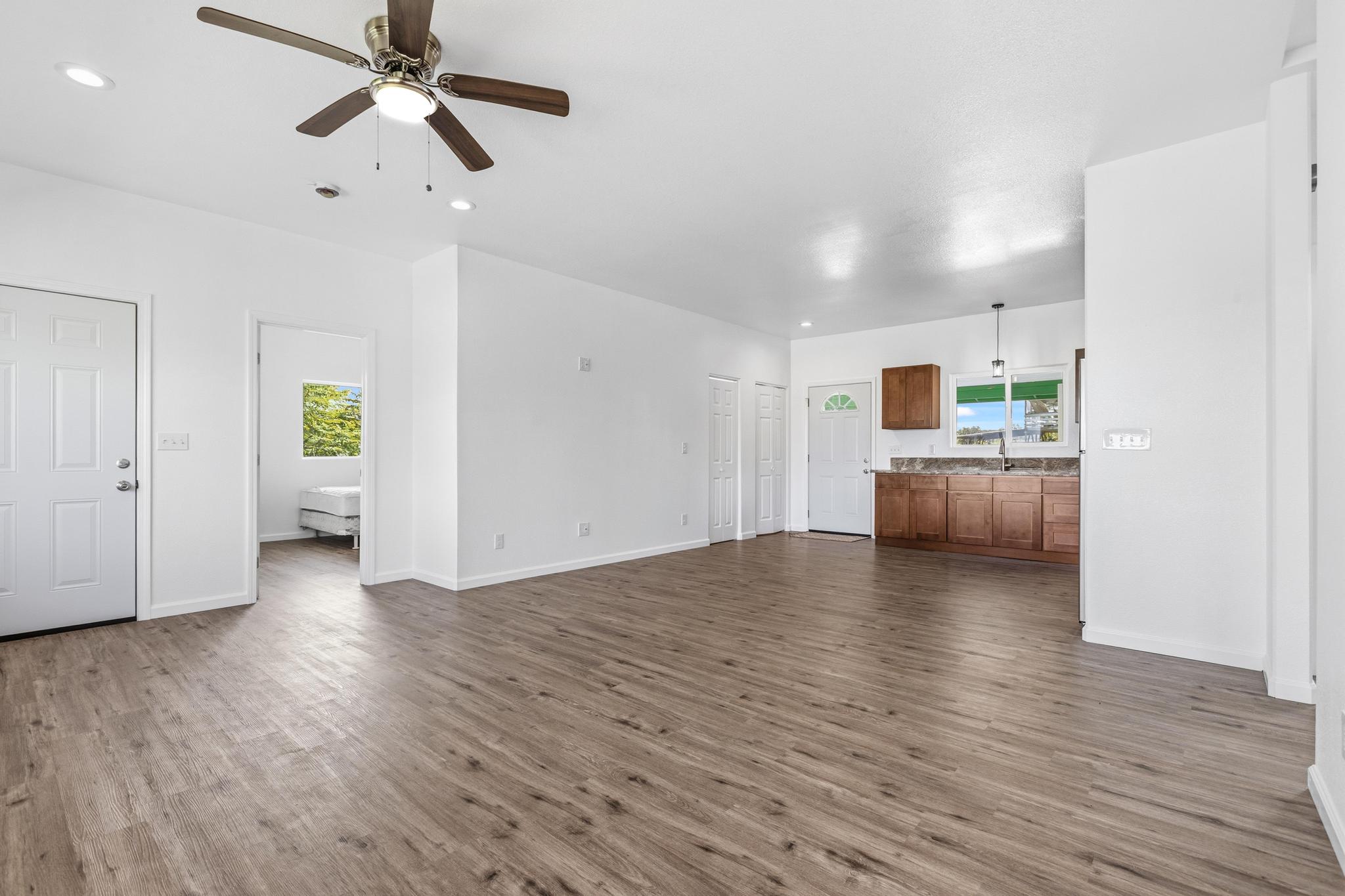 18-7842 Kaniela Road Mountain View, HI 96771 - Photo 6 of 30 a view of empty room with wooden floor and ceiling fan