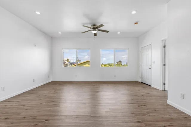 an empty room with a empty space and windows