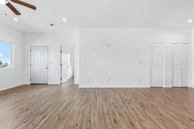 an empty room with wooden floor