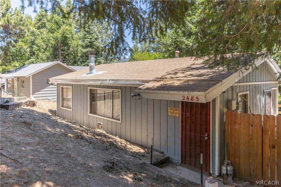 2485 Spring Drive Running Springs, CA 92382 - Photo 10 of 10 a house with trees in the background