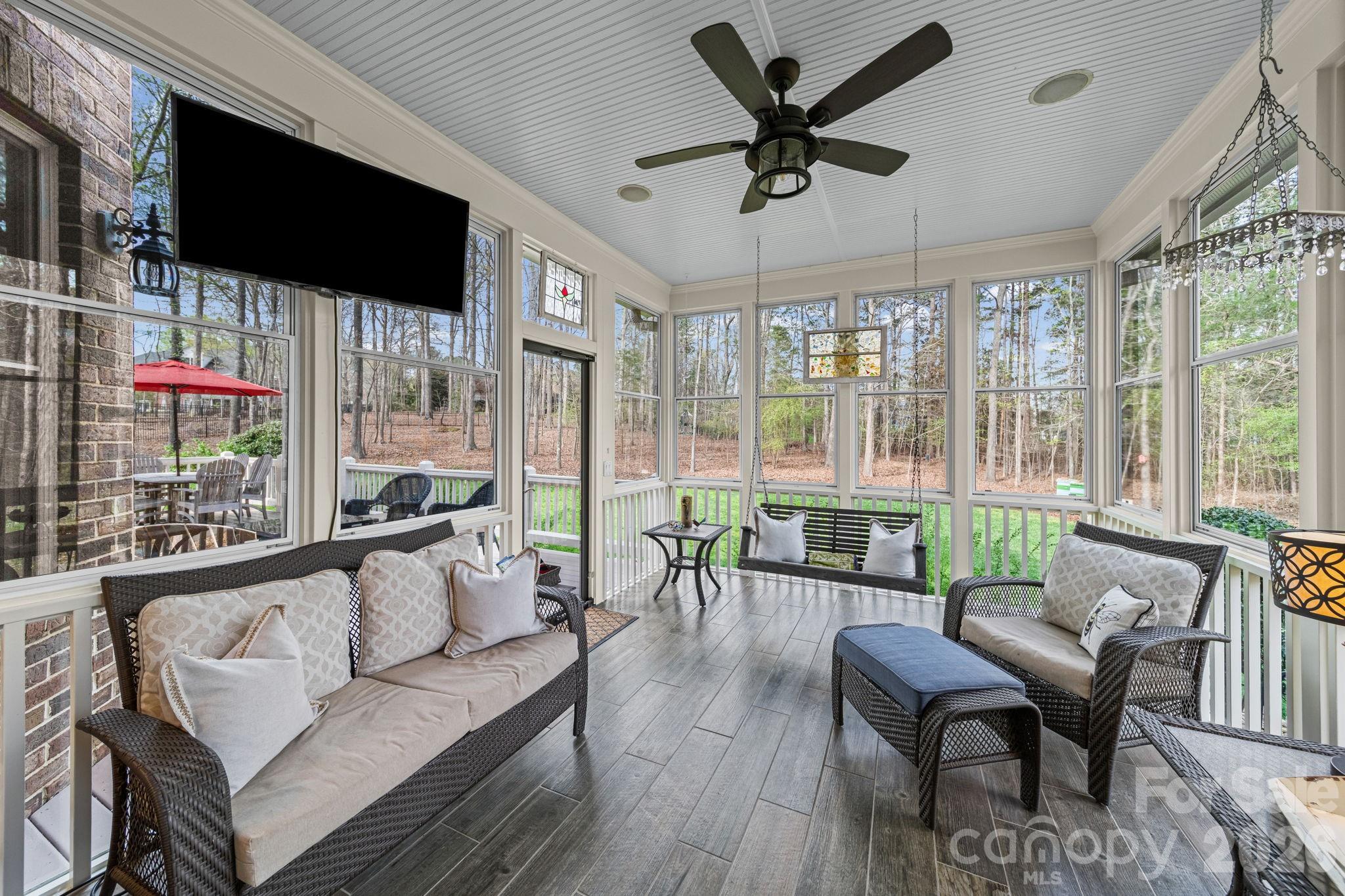 1802 Summit View Place Waxhaw, NC 28173 - Photo 39 of 47 a living room with furniture tv and a floor to ceiling window