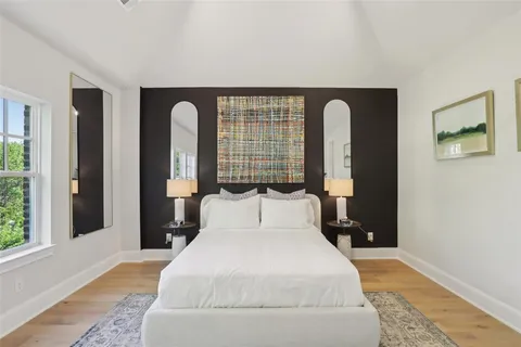 a bedroom with a large bed and a large window