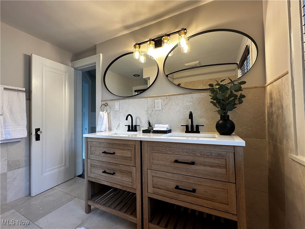 2255 Edgerton Road University Heights, OH 44118 - Photo 20 of 33 Bathroom with backsplash, dual bowl vanity, and tile patterned flooring