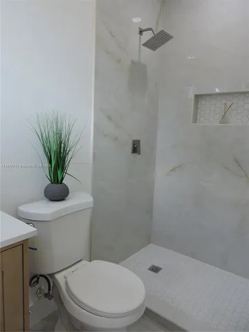 an empty room that has a bathroom in it