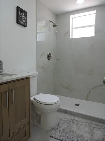 a view of two room with closet and window