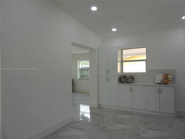a kitchen with refrigerator and window