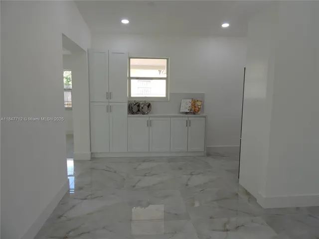 a kitchen with a refrigerator and a sink
