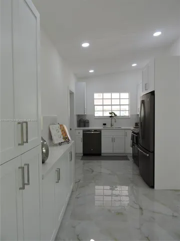 a kitchen with a sink and steel stainless steel appliances