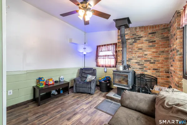 a living room with furniture a fireplace and a chandelier