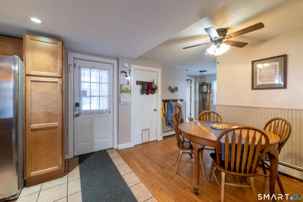 a view of a dining room with furniture and a chandelier fan