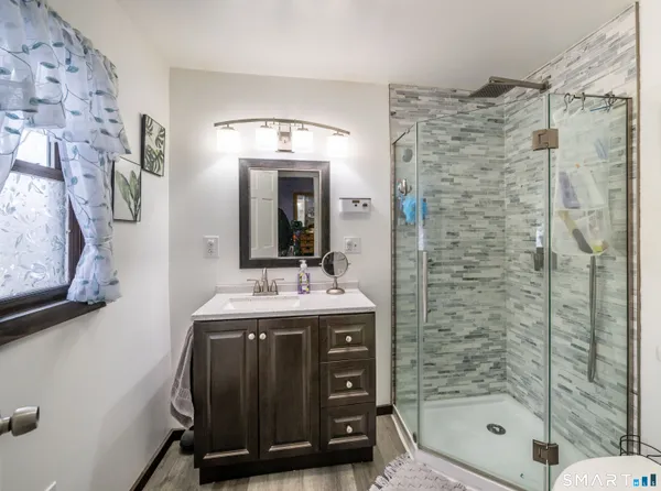 a bathroom with a sink a mirror and a shower