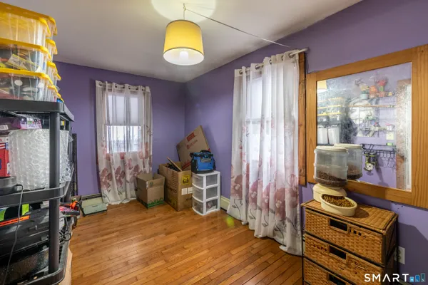 a bedroom with furniture and a flat screen tv