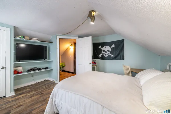 a bedroom with a bed and a flat screen tv