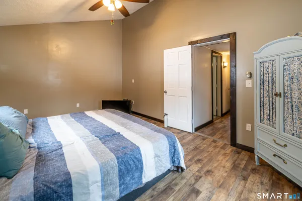 a bedroom with a bed and a chandelier
