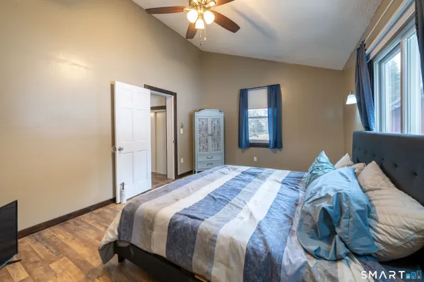 a bedroom with a bed and a chandelier