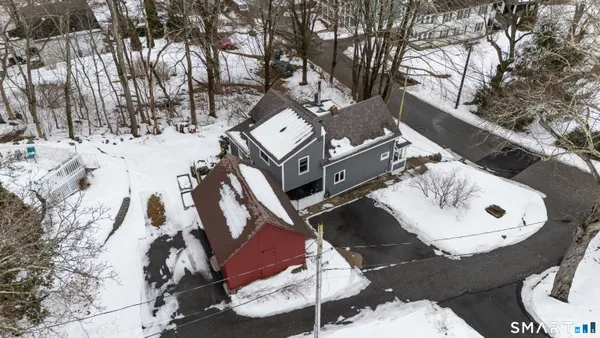 an aerial view of a backyard with table and chairs