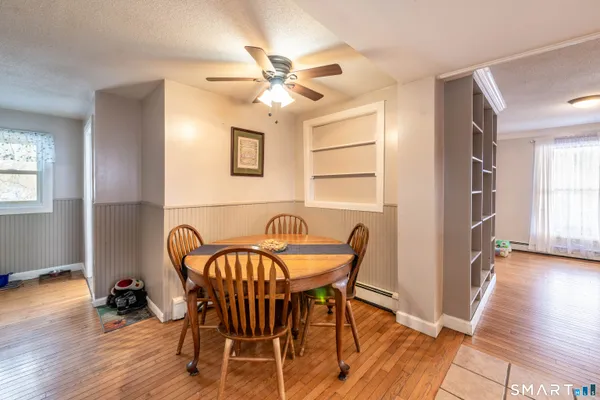 a view of a dining room with furniture and wooden floor