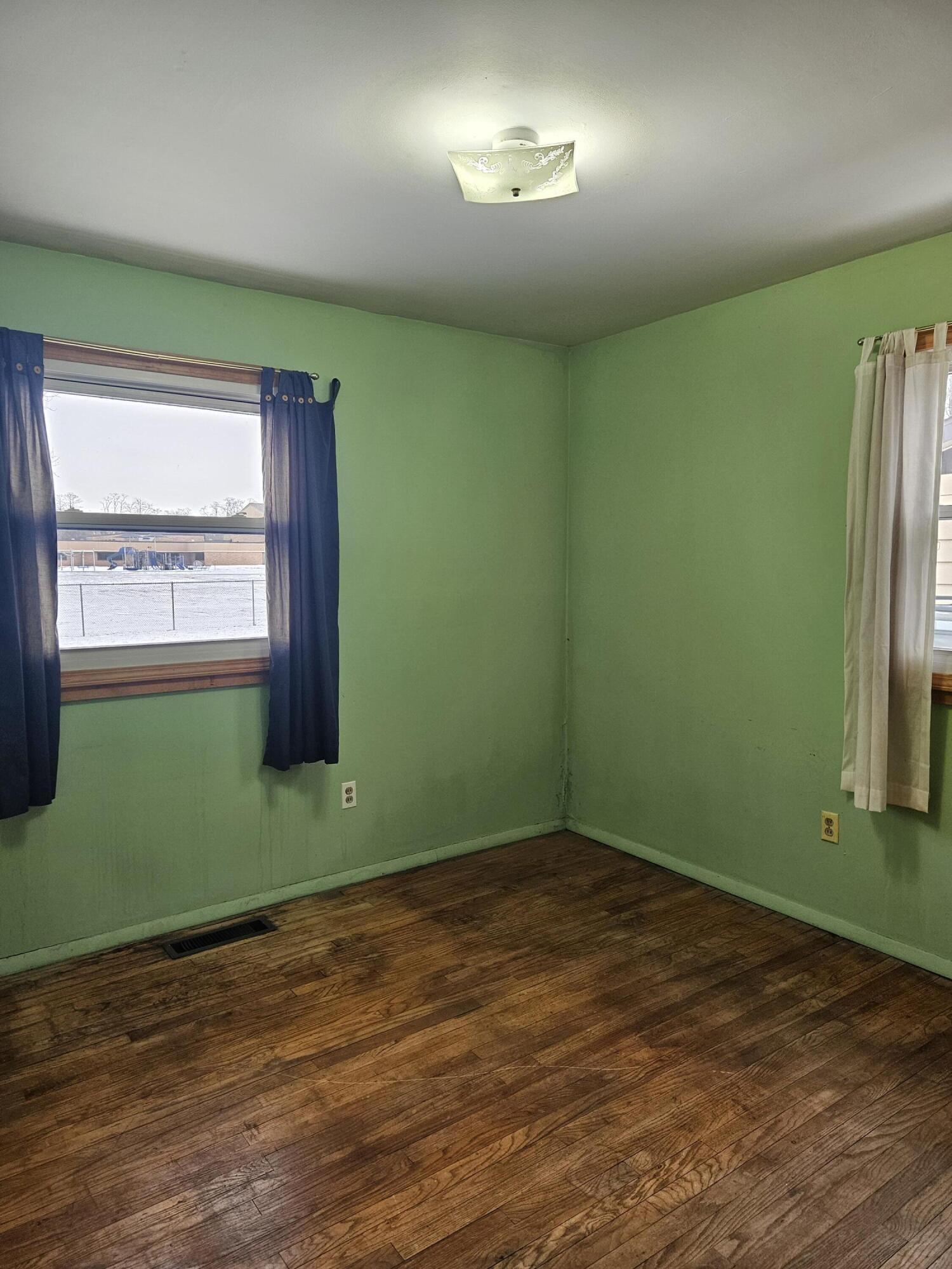 309 Redpath Avenue Michigan City, IN 46360 - Photo 14 of 27 an empty room with a window and a wooden floor