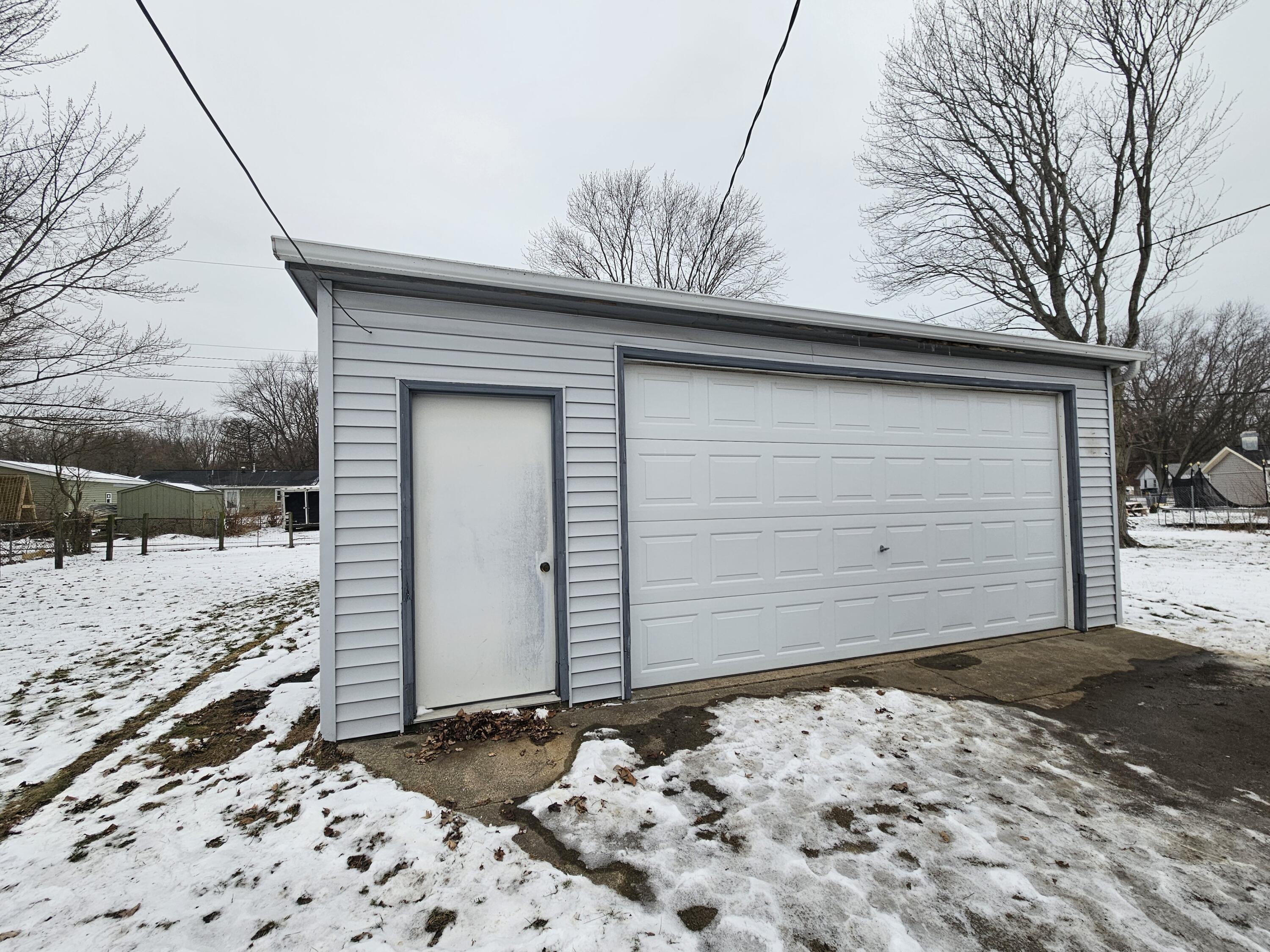 309 Redpath Avenue Michigan City, IN 46360 - Photo 20 of 27 a view of a house with a snow on the road