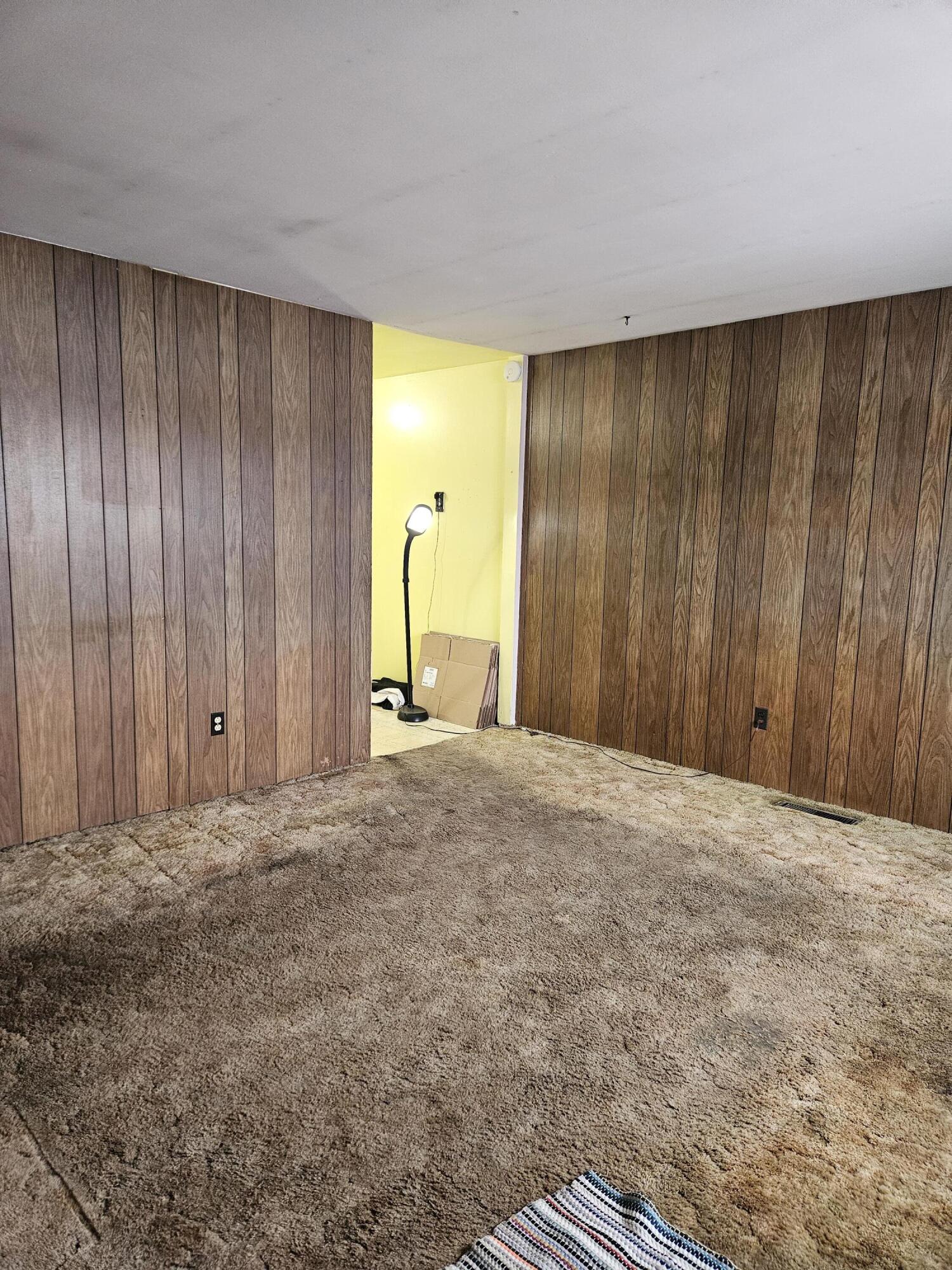 309 Redpath Avenue Michigan City, IN 46360 - Photo 6 of 27 a view of an empty room with wooden walls