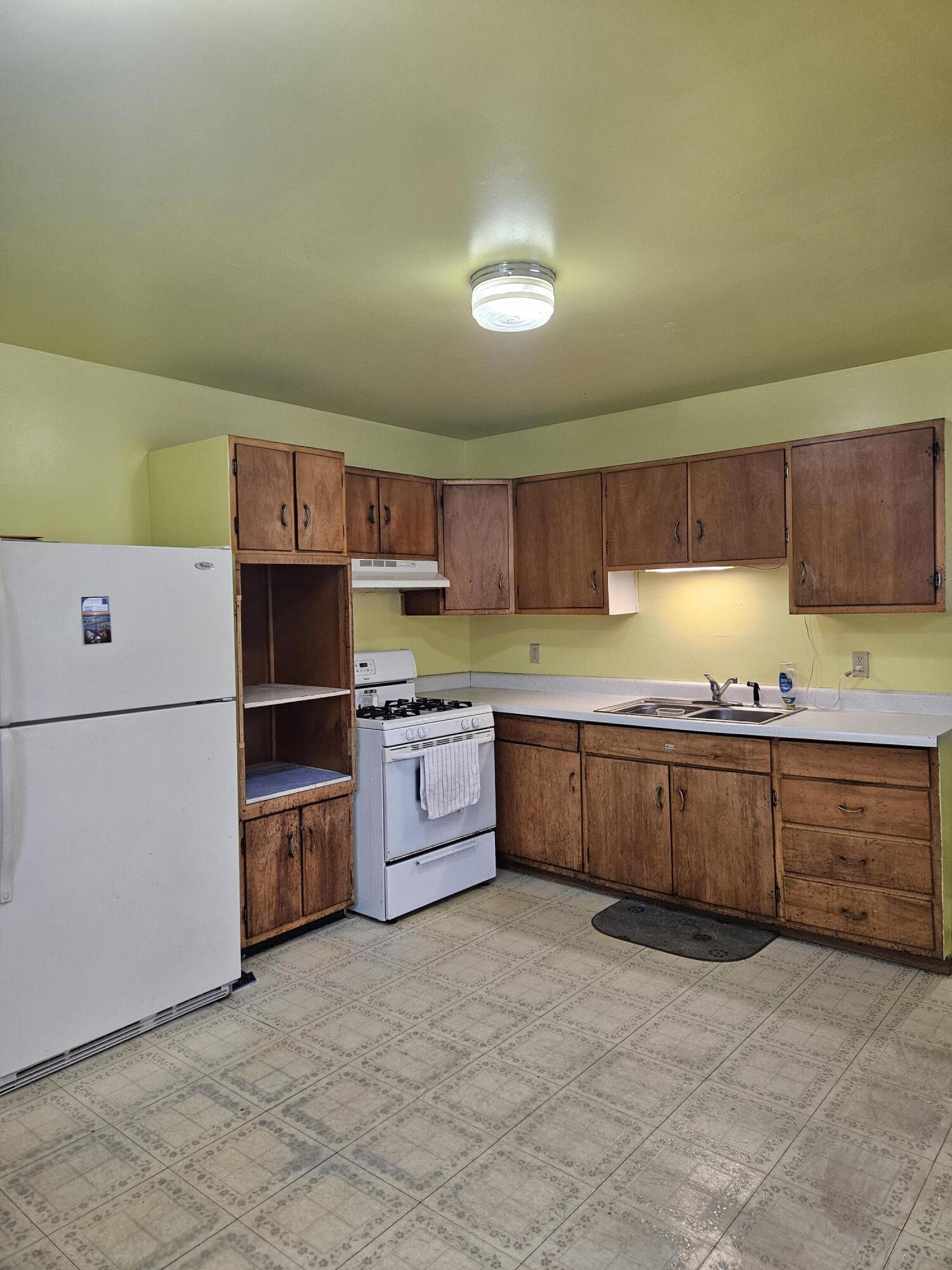 309 Redpath Avenue Michigan City, IN 46360 - Photo 8 of 27 a kitchen with stainless steel appliances granite countertop a stove a sink and a refrigerator