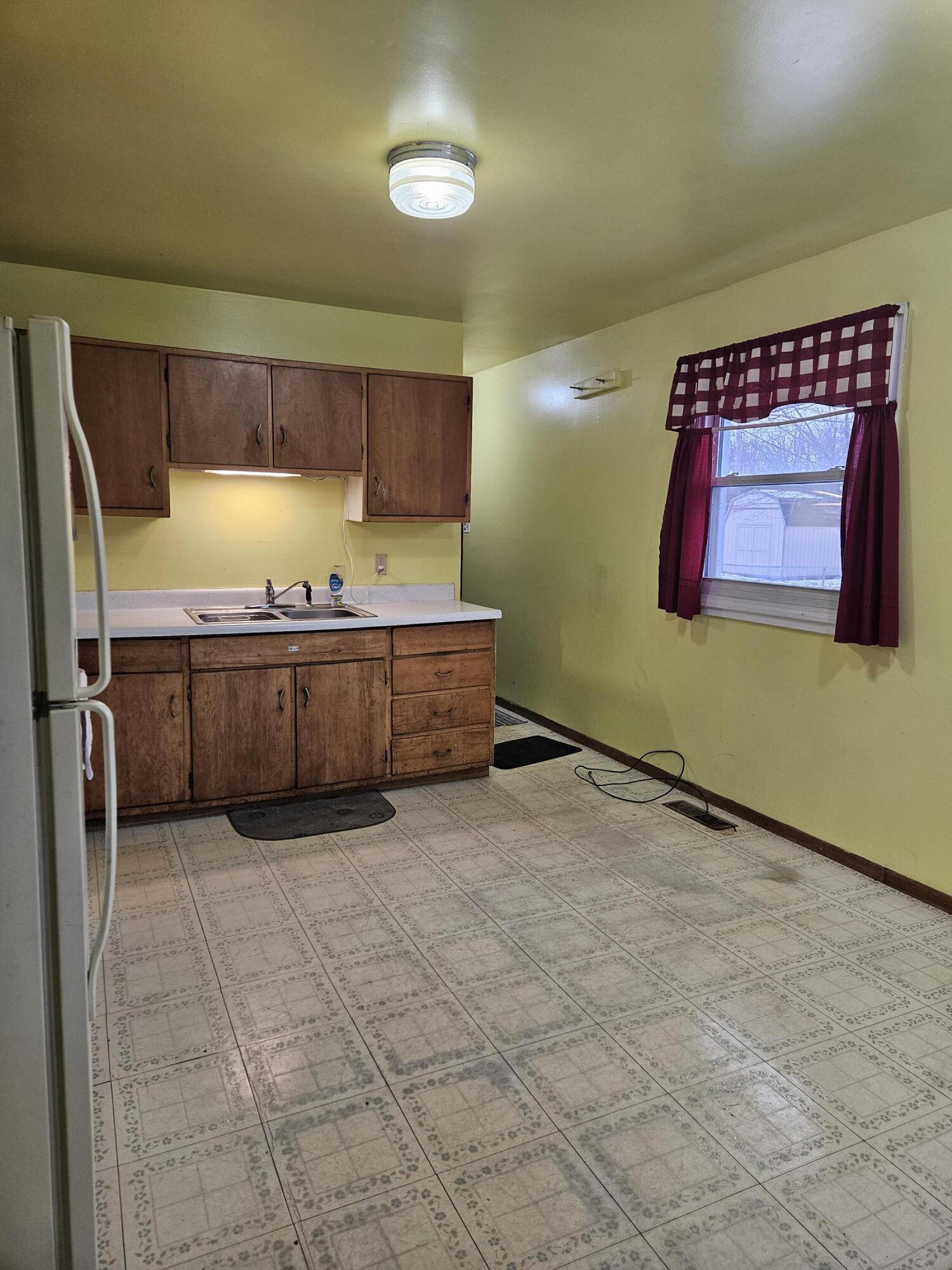 309 Redpath Avenue Michigan City, IN 46360 - Photo 9 of 27 a view of a kitchen with stainless steel appliances granite countertop a sink and cabinets