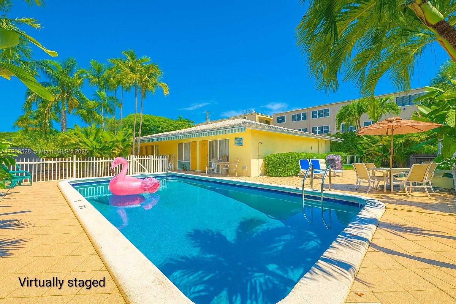 3217 Northeast 7th Place, Unit 1 Pompano Beach, FL 33062 - Photo 1 of 28 a view of a swimming pool with a patio